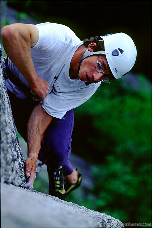 Bruce on Planet Caravan: Squamish, BC, Canada (2002-00-00) - Climbing photo of a climber scaling a granite slab, high above the shaded forest floor