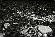 Flat Water, Rocks (B&W): Near Manning Park, BC, Canada (2005) - Fine art black and white photograph of pale and dark rocks in a flat, calm river