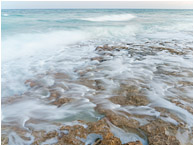 Limestone, Smokey Sea: Cozumel, Mexico (2010) - Fine art photograph of waves crashing on a limestone island, smokey and blurred by a long exposure