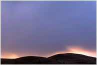 Sweeping Light, Clouds: Near Penticton, BC, Canada (2002) - Fine art photograph of storm clouds over the hills at sunset