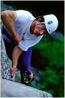 Bruce on Planet Caravan: Squamish, BC, Canada (2002) - Climbing photo of a climber scaling a granite slab, high above the shaded forest floor