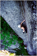 Chris on Planet Caravan: Squamish, BC, Canada (2002) - Climbing photo of a climber scaling a thin crack in a large, intimidating corner, high above the ground