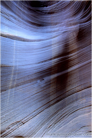Abstract photograph of streaked, textured sandstone in a slot canyon