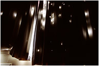 Curtains, Holes: Near Seattle, WA, USA (2006) - Abstract photograph of light streaming through holes in hotel curtains