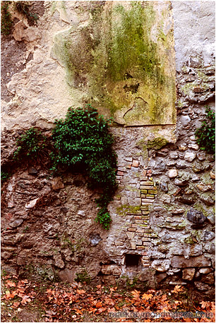 Fine art photograph showing layers of ancient construction in an exposed concrete wall