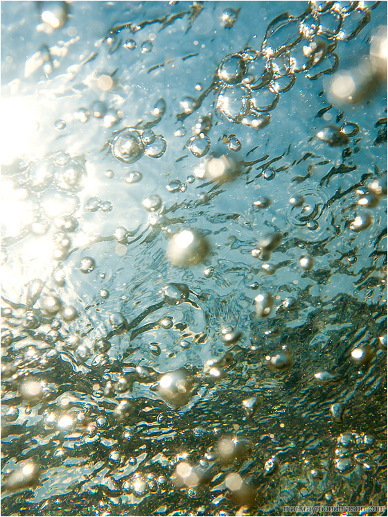 Surface Bubbles, Refracted Sky: Near San Ignacio, Belize (2010-05-10) - Abstract photograph of bubbles and refracted skylight from below the surface of the water