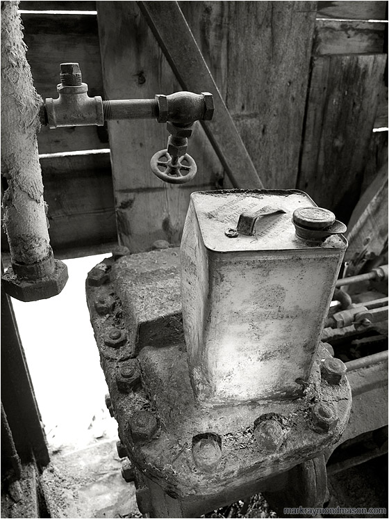 Valves, Metal Can, Daylight (B&W): Near Dawson, YT, Canada (2010-09-10) - Fine art black and white photograph showing a petrol can inside the remains of an ancient excavator