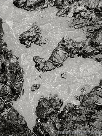 Fine art abstract photograph of rain-washed rocks and a translucent flat tide pool
