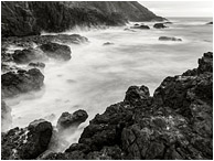 Steep Bay, Smokey Sea: Near Stawberry Hill Park, OR, USA (2015) - Fine art black and white long exposure photograph of waves crashing on a rugged bay