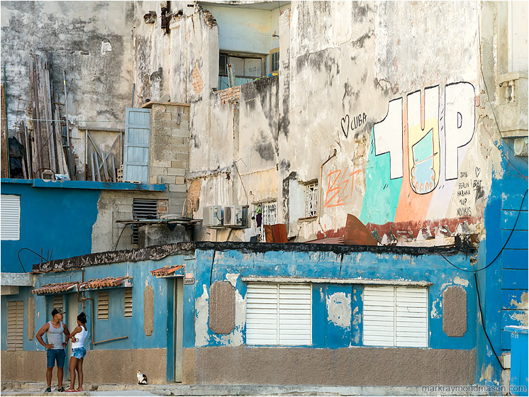 Standing Couple, Broken Walls, Graffiti: Havana, Cuba (2017-02-18) - Fine art travel photograph showing a young Cuban couple talking in front of the ruins of a large concrete building