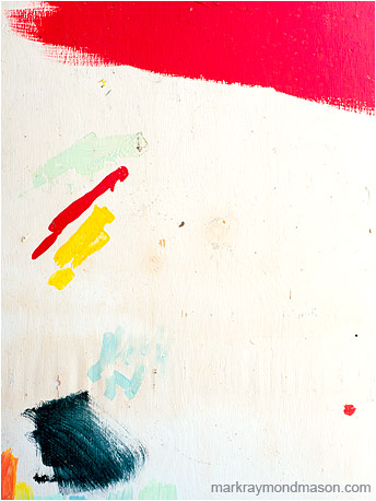 Abstract fine art photograph showing brightly coloured brush strokes on a white concrete wall
