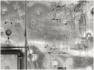 Dented Metal, Hinges: Salmon Arm, BC, Canada (2018) - Fine art abstract black and white photo showing a closeup of a dented metal train kiosk, reflected light forming patterns in the surface