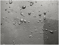 Concrete Wall, Blistered Paint: Vancouver, BC, Canada (2018) - Black and white abstract photograph showing a pattern of bubbles on a crudely painted concrete wall